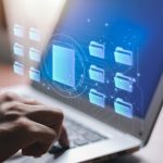 Hand tippt auf Laptop-Tastatur, während digitale Ordner- und Dokumentensymbole auf dem Bildschirm schweben – symbolisiert digitales Bewerbermanagement oder Datenorganisation.